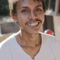29676 32 year old Hamdani with his two year old son Restu. Hamdani made Adidas sports shoes until 2005 when he was unfairly dismissed for participating in a strike for better wages. Photo: Tim Herbert/OxfamAUS