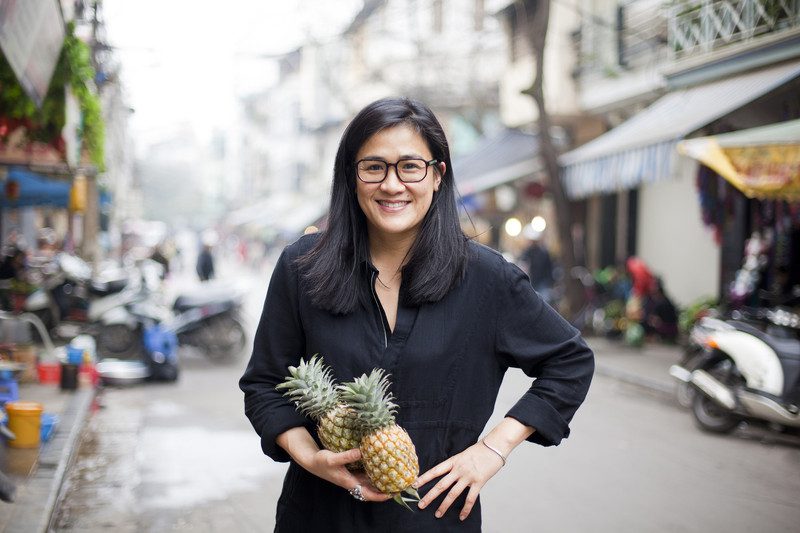 Kylie Kwong with pineapples at a market in Hanoi