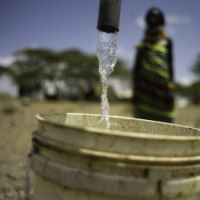 Fresh water drips from a pipe installed by Oxfam in the village of Nawoyatir. Photo: Kieran Doherty/Oxfam
