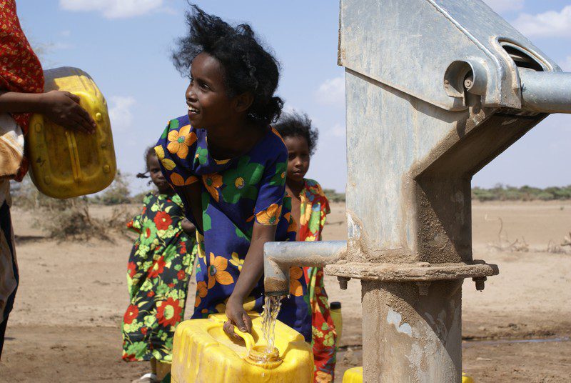 Women and children gather in Harre village as a jerry can washing campaign gets underway in Shinile, Ethiopia.