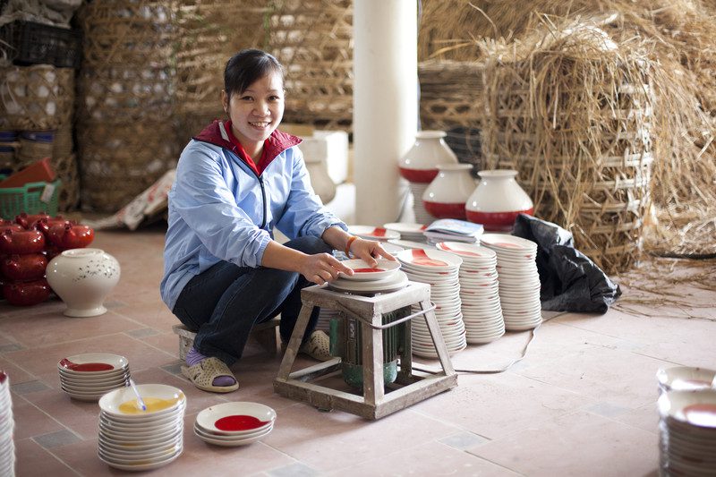 Dinh Thi Nhan polishing fair trade plates at Giang Phong II ceramics workshop in Mai, near Hanoi