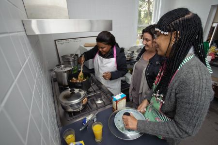 Roseline and Collette cook alongside Oxfam Ambassador Julie Goodwin. Photo: Michael Myers/OxfamAUS