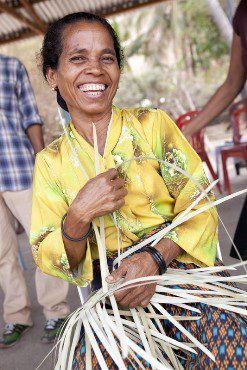Alysia does some weaving. Photo: Timothy Herbert/OxfamAUS