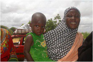 Kadija Hamsoou and her son Haruna, collecting household items in Niamey, Niger. Photo: Louise Mooney/OxfamAUS