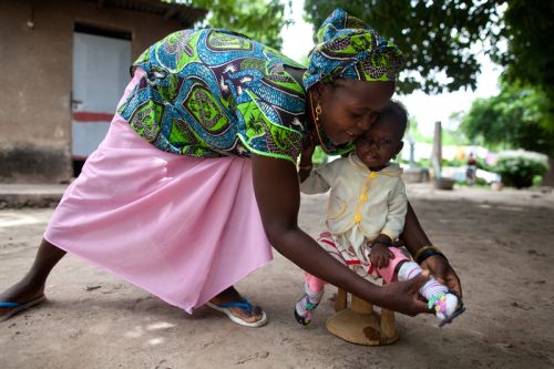 A mother cares for her daughter, who is recovering from severe malnutrition in an emergency feeding center run by a Catholic mission. Our programs are aimed at preventing food shortages from becoming health emergencies like this. Photo: Holly Pickett/Oxfam