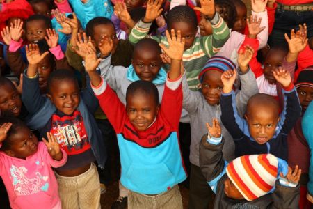 Pupils from Nokuthula's creche wave to the camera. Photo: Matthew Willman/OxfamAUS