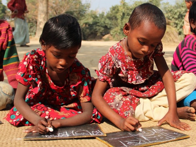 Rita Baroar, 5 years old with her friend, doing lessons at Muraripur Preschool. Photo: Tania Cass