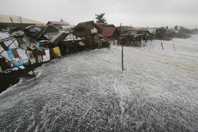 Strong waves crash into coastal houses as Typhoon Hagupit pounds Legazpi, Albay province, eastern Philippines on Sunday. Photo: AP/Aaron Favila Strong waves crash into coastal houses as Typhoon Hagupit pounds Legazpi, Albay province, eastern Philippines on Sunday, Dec. 7, 2014. Photo: AP/Aaron Favila