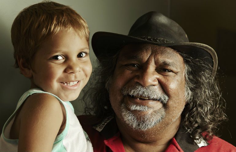 A young Aboriginal child and an older Aboriginal man pose together to highlight the need to Close the Gap for the next generation