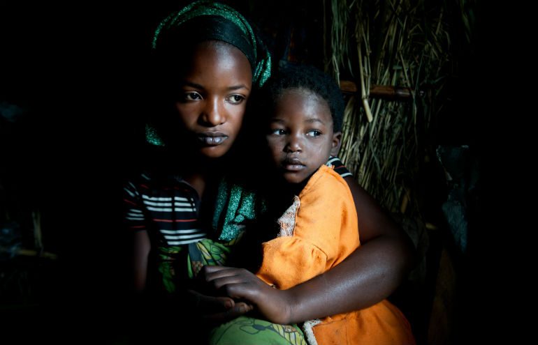 Louise's children hold eachother in Buporo Camp in the Democratic Republic of Congo