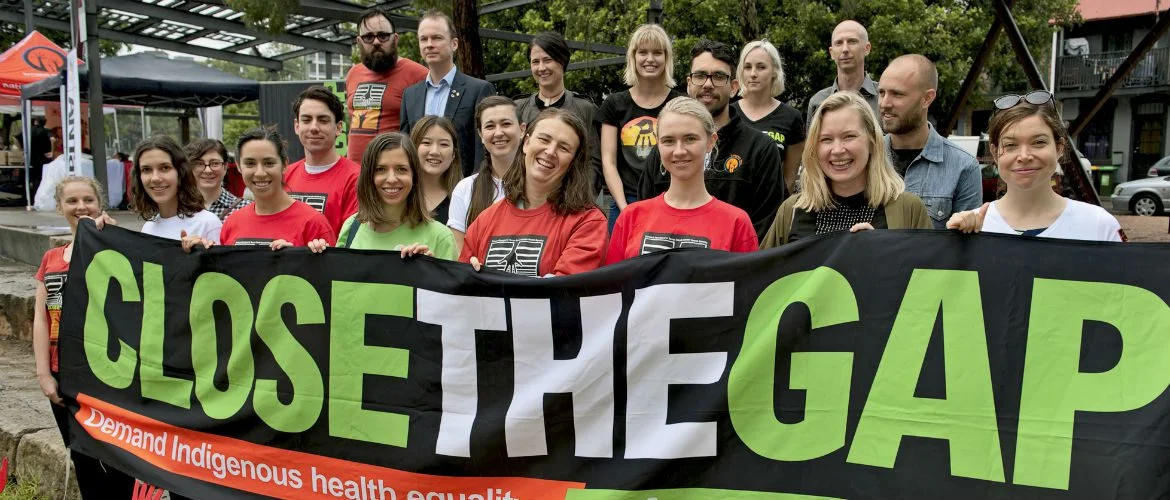 Photo: Jon Love/OxfamAUS National Close the Gap participants hold a banner in support of Indigenous health equality