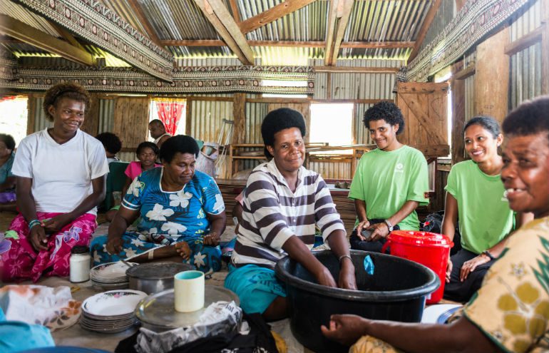 Mere Liku (centre) with other women of the village of Nasiriti in Fiji are washing the dishes affter a community gathering. Oxfam is supporting them with soap, buckets and other sanitation tools to prevent the spread of diseases.