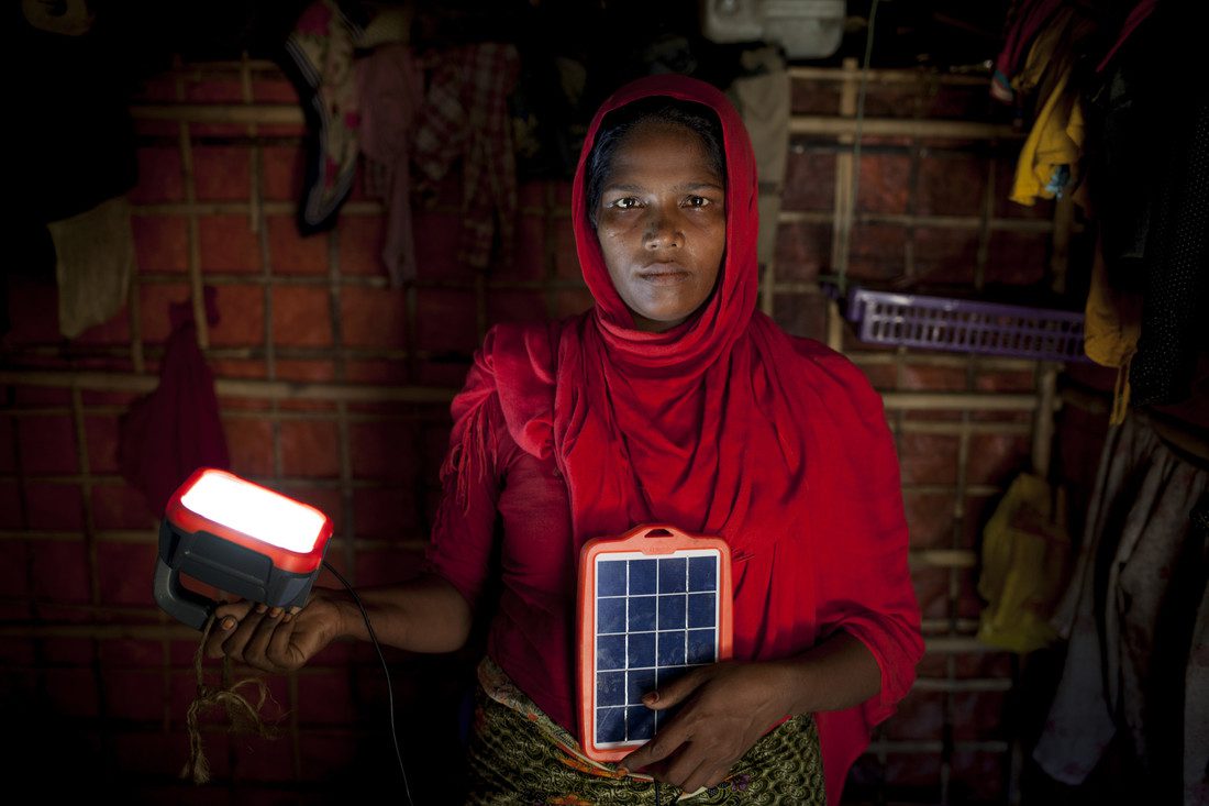 Rohingya refugee Asia Bibi* with solar powered lamp provided by Oxfam, in her shelter in the camps in Cox’s Bazar, Bangladesh. Photo: Abbie Trayler-Smith/ Oxfam