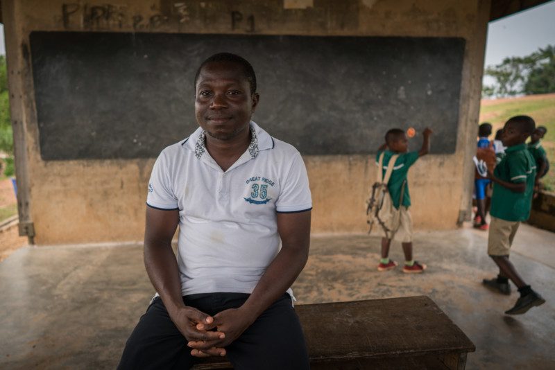 Mr. Job Nyarko, the headmaster of the local school in Ayanfuri, poses in one of the open-air classrooms. Photo: Nana Kofi Acquah/OxfamAUS
