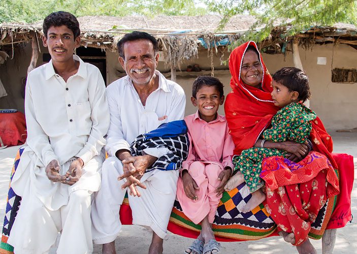 Gudi (in red) with her family, Pakistan. Photo: Oxfam in Pakistan
