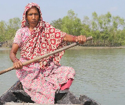 A woman rows a boat over a swelling river