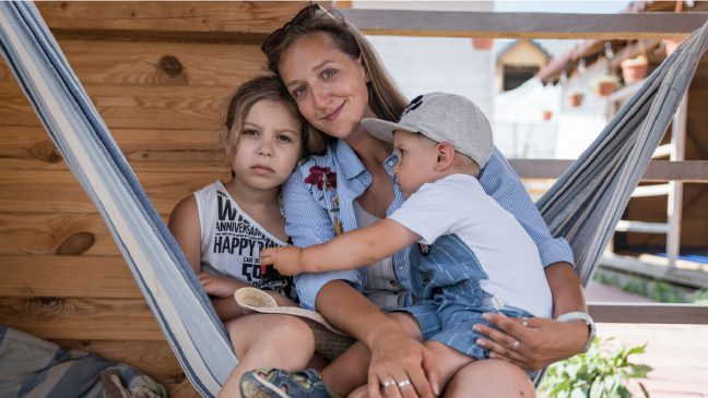 Katerina, a 34-year-old Ukrainian refugee from Odessa, together with her son Miron*, 2 and her daughter Daria*, 8, in the backyard of the Bronx People Association, August 3rd, 2022. *Name changed to protect identity Katerina, a 34-year-old Ukrainian refugee from Odessa, together with her son Miron*, 2 and her daughter Daria*, 8, in the backyard of the Bronx People Association, August 3rd, 2022. *Name changed to protect identity