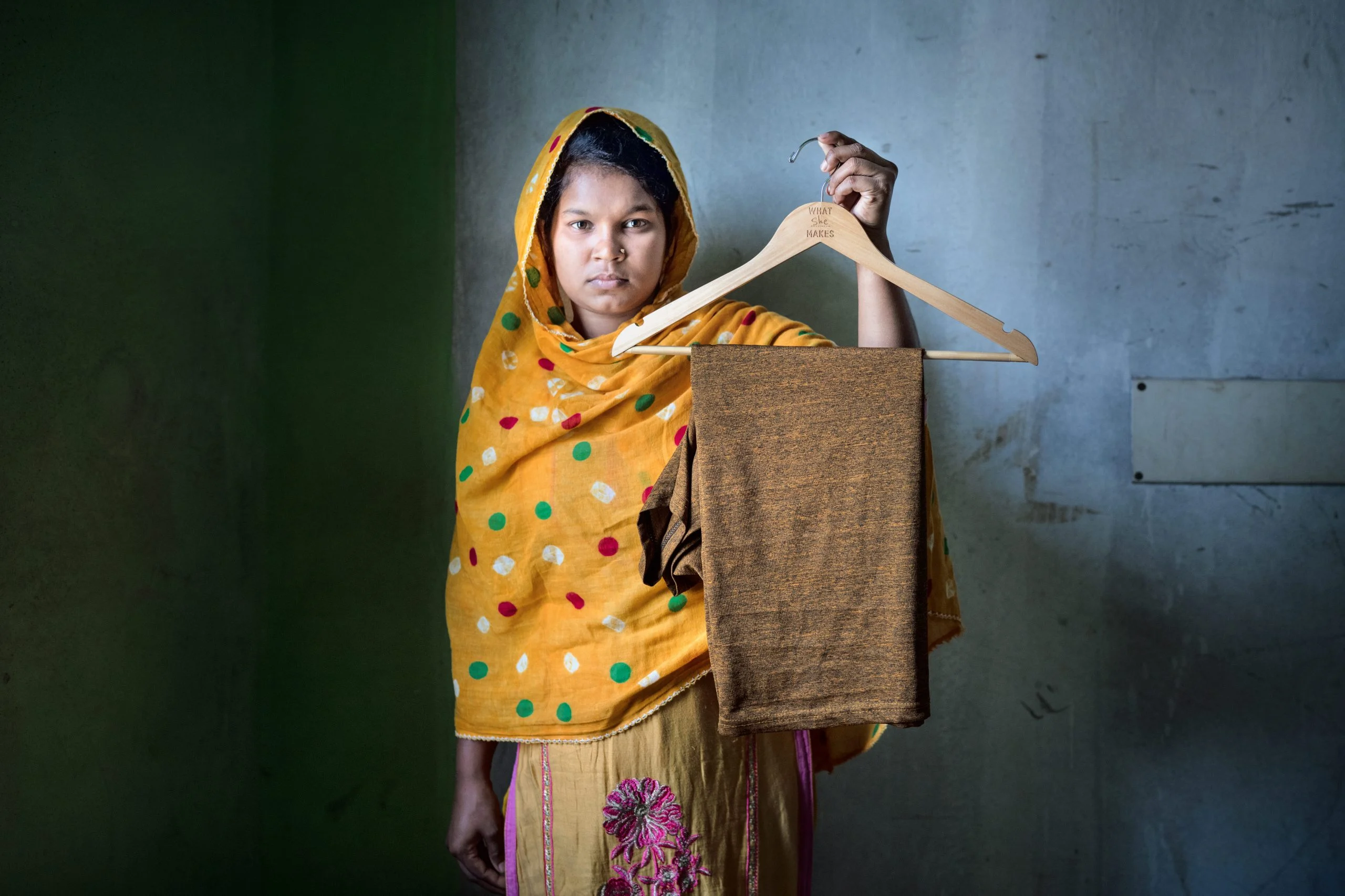 Rumi Akter is working as garment workers for three years now. She is living along her sister, who also works in a garment factory. As helper she fold fabrics and match them. Her target is 1440 pieces in 8 hours. With overtime she gets 10000 taka which is not enough for her living in Asulia. She can barely send money to her parents. Asulia, Bangladesh. Photo: Fabeha Monir/Oxfam Bangladesh: Rumi Akter is working as garment workers for three years now. Her target is 1440 pieces in 8 hours. With overtime she gets 10000 taka which is not enough for her living in Asulia. Photo: Fabeha Monir/Oxfam