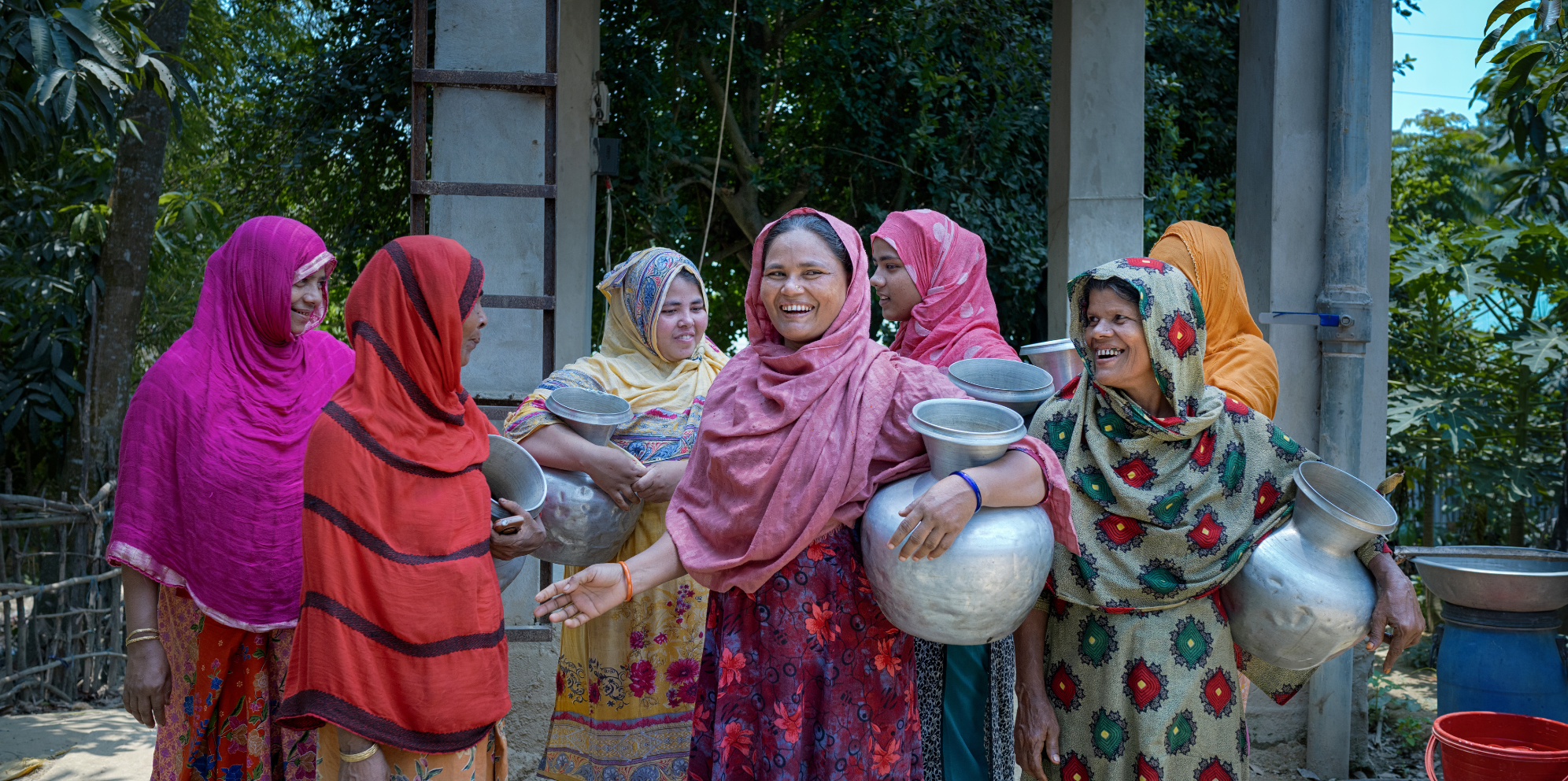 Bangladesh: Jannat with women from her community. Jannat lives in Nayapara, in the Cox's Bazar area which hosts over 1.7 million Rohingya refugees. Her community was severely impacted by water scarcity until Oxfam partner organisation NGO Forum installed a Mini Piped Water Distribution Network, enabling community members to access safe, clean water whenever they need. Photo: Fabeha Monir/Oxfam. Oxfam acknowledges the support of the Australian Government through the Australian Humanitarian Partnership (AHP).