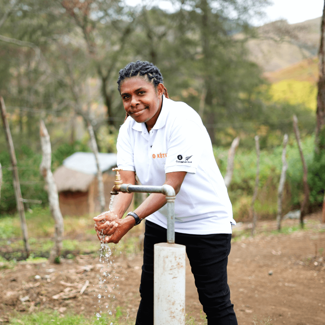 Papua ​New ​Guinea: Maigao, WASH Program Quality Officer, using a tap recently installed in the hamlet. Photo: Aimee Han/Oxfam